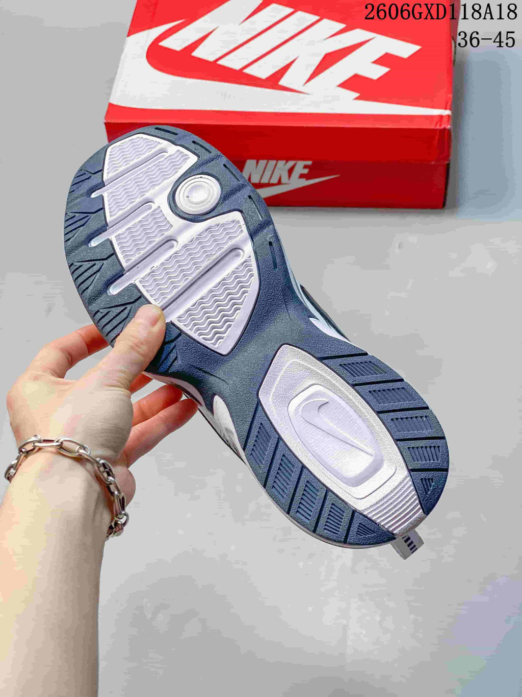 Underside of a Nike Air Monarch sneaker showing a two-tone patterned outsole.