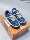 Pair of blue patterned Louis Vuitton Tilted Low sneakers with white laces and a chunky sole, shown on a patterned box.