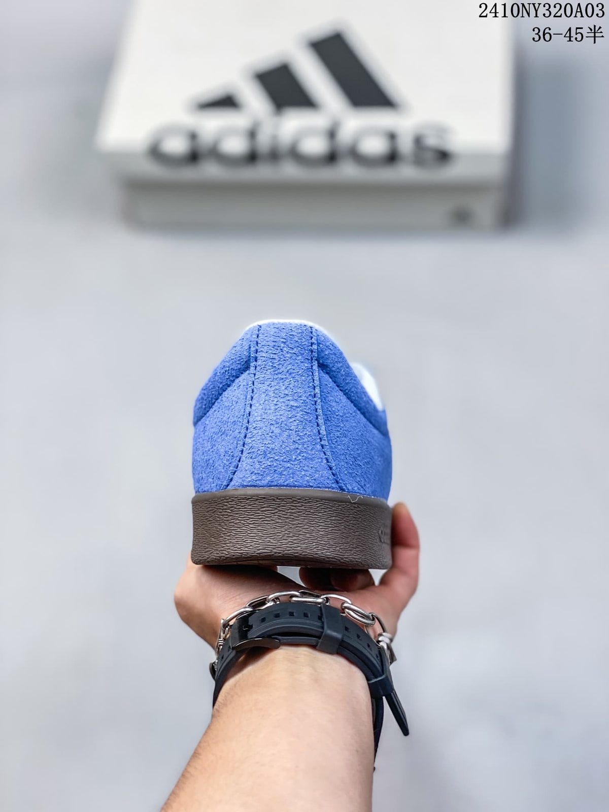 Rear view of a blue sneaker showing the heel and dark brown outsole