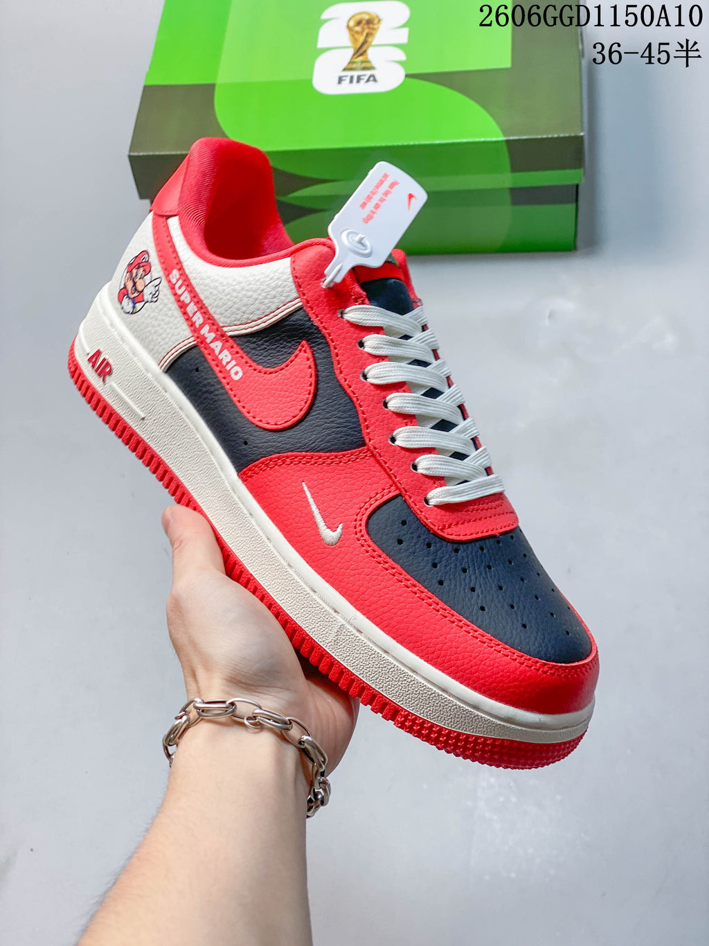 Angled side view showing red, navy, and off-white color blocking and graphic details.
