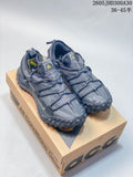 Pair of gray Nike ACG Mountain Fly Low GTX SE shoes displayed on an ACG box