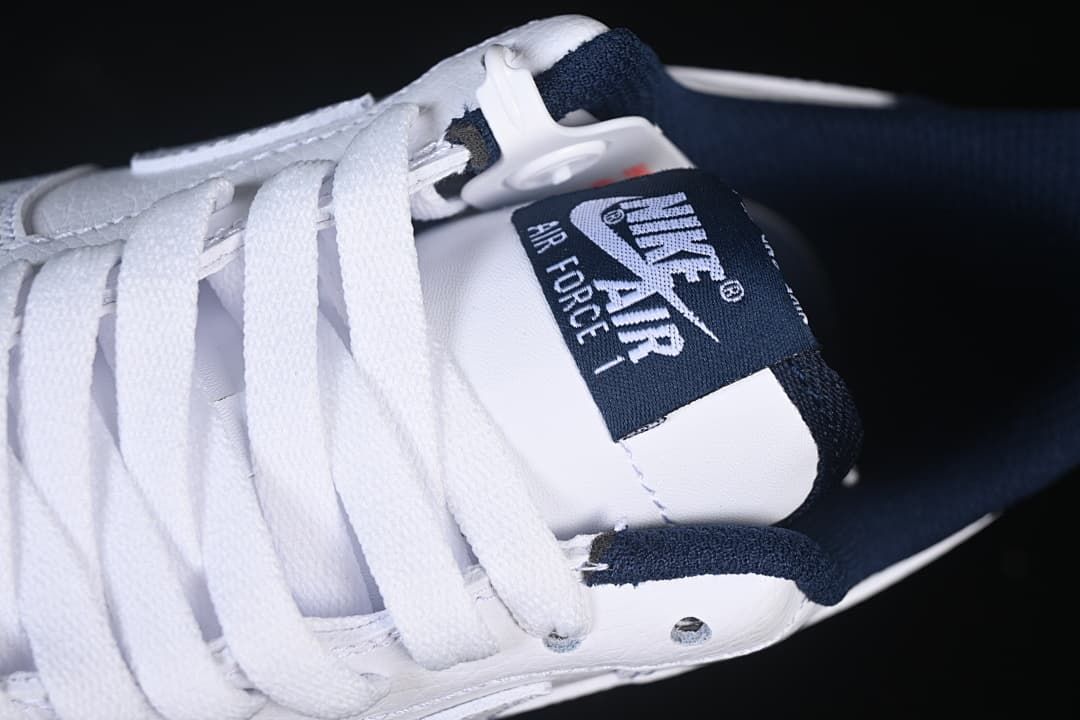 Close-up of the tongue label, white laces, and navy collar