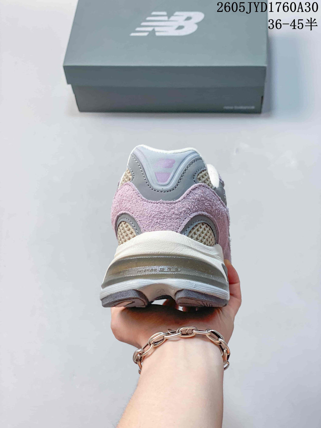 Heel view showing the layered panels and sole of a New Balance 2010 sneaker.