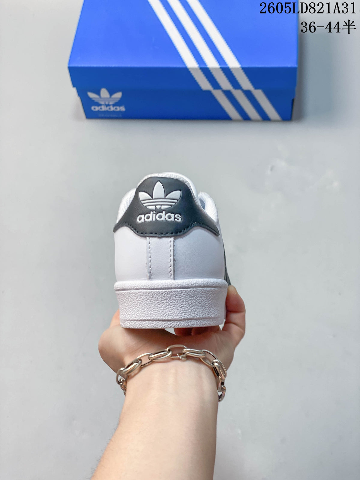 Rear view of a white sneaker with a dark heel tab.