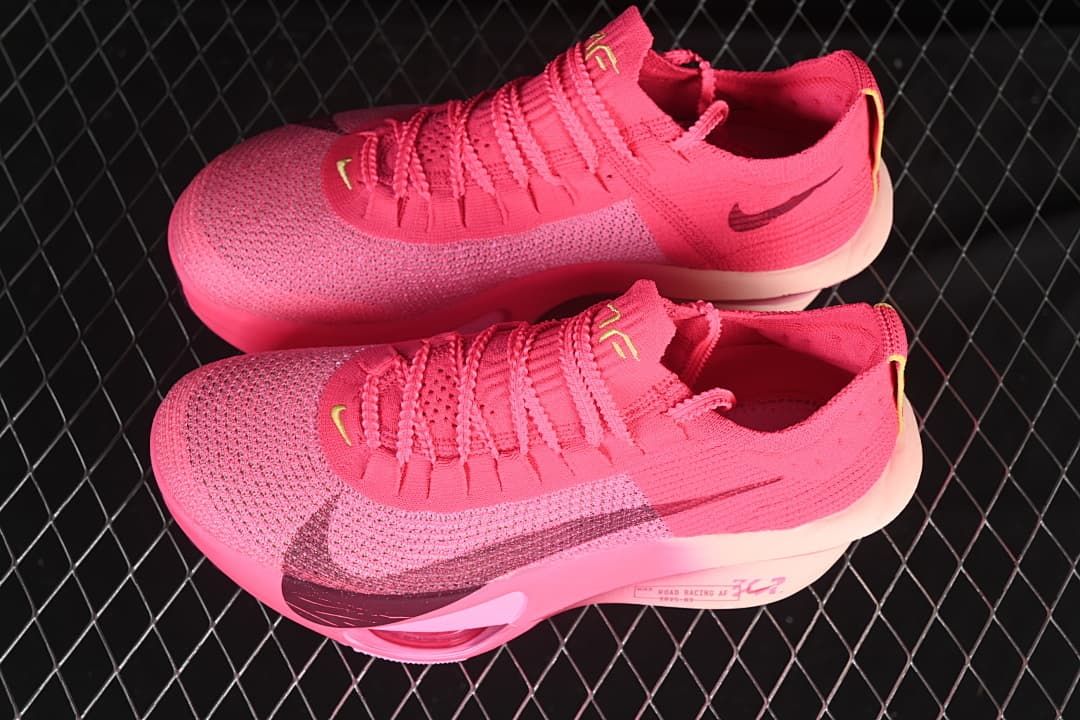 Pair of pink running shoes shown from above and the side