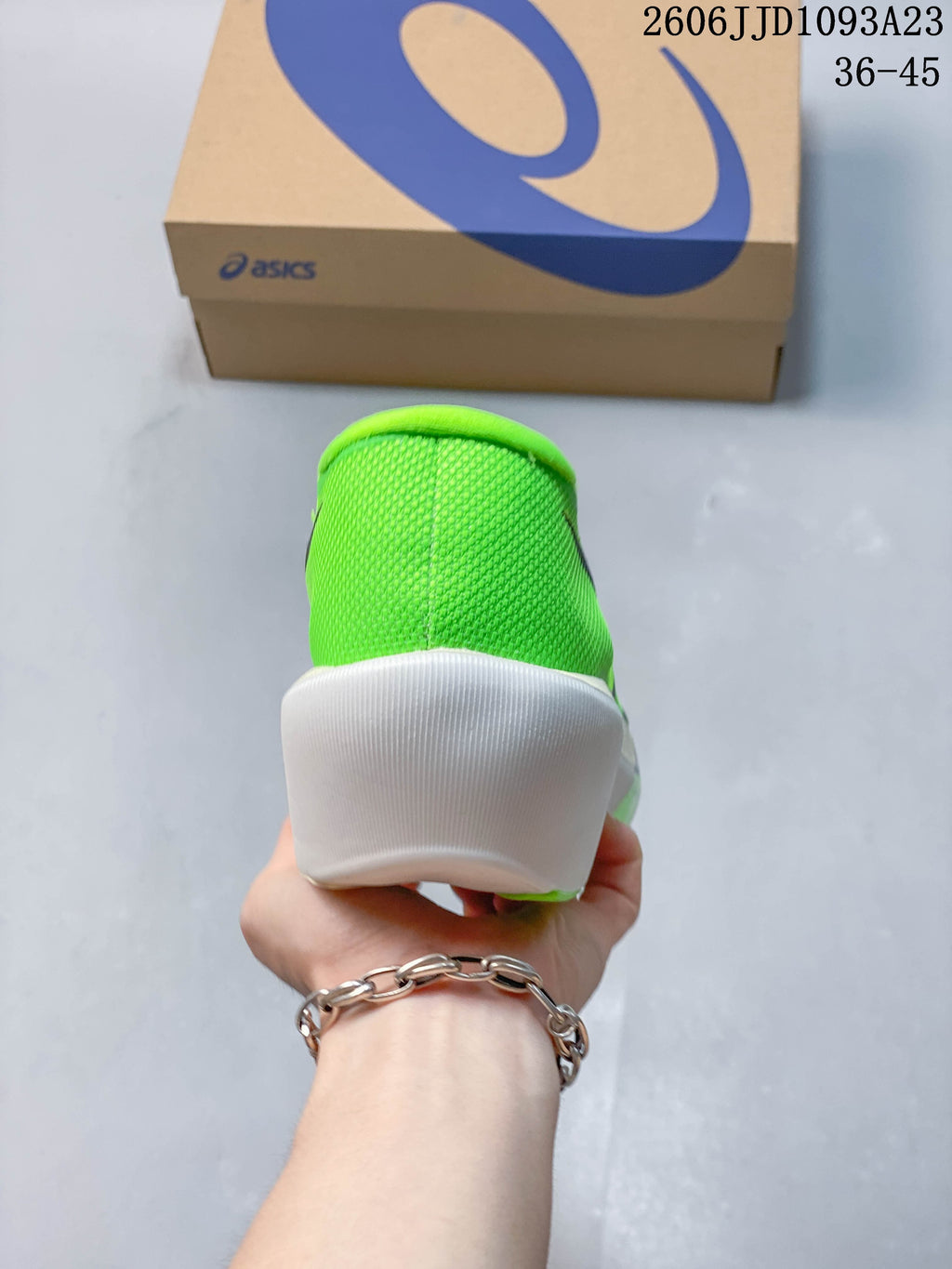 Rear view of the bright green running shoe with a white heel section