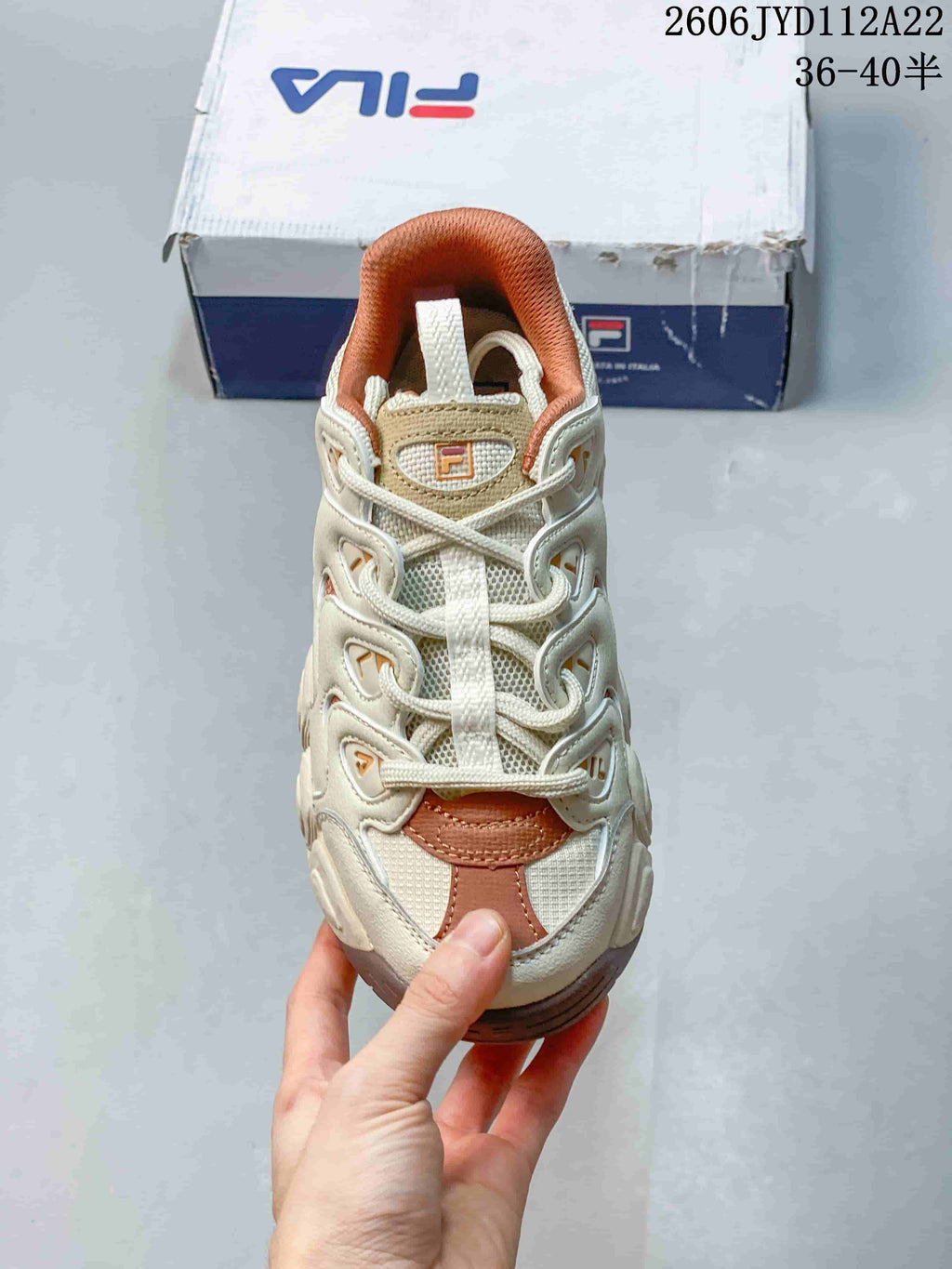 Front view of the lace-up sneaker with layered panels
