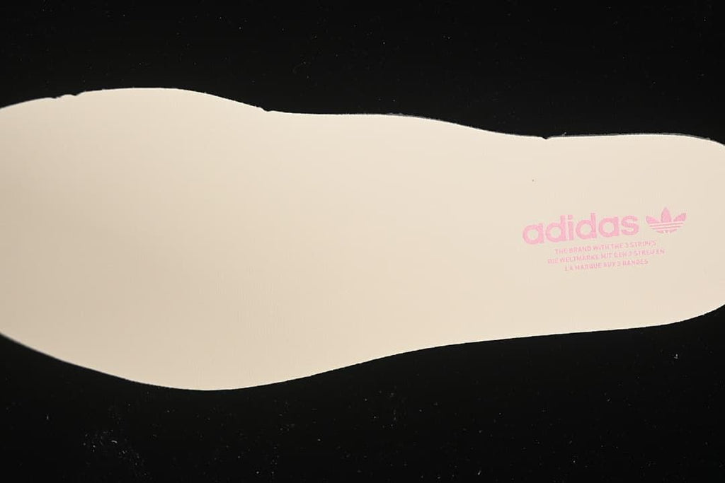 Cream-colored insole with adidas branding