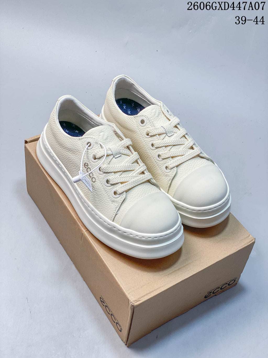 Pair of white ECCO low-top lace-up sneakers with textured uppers and thick soles
