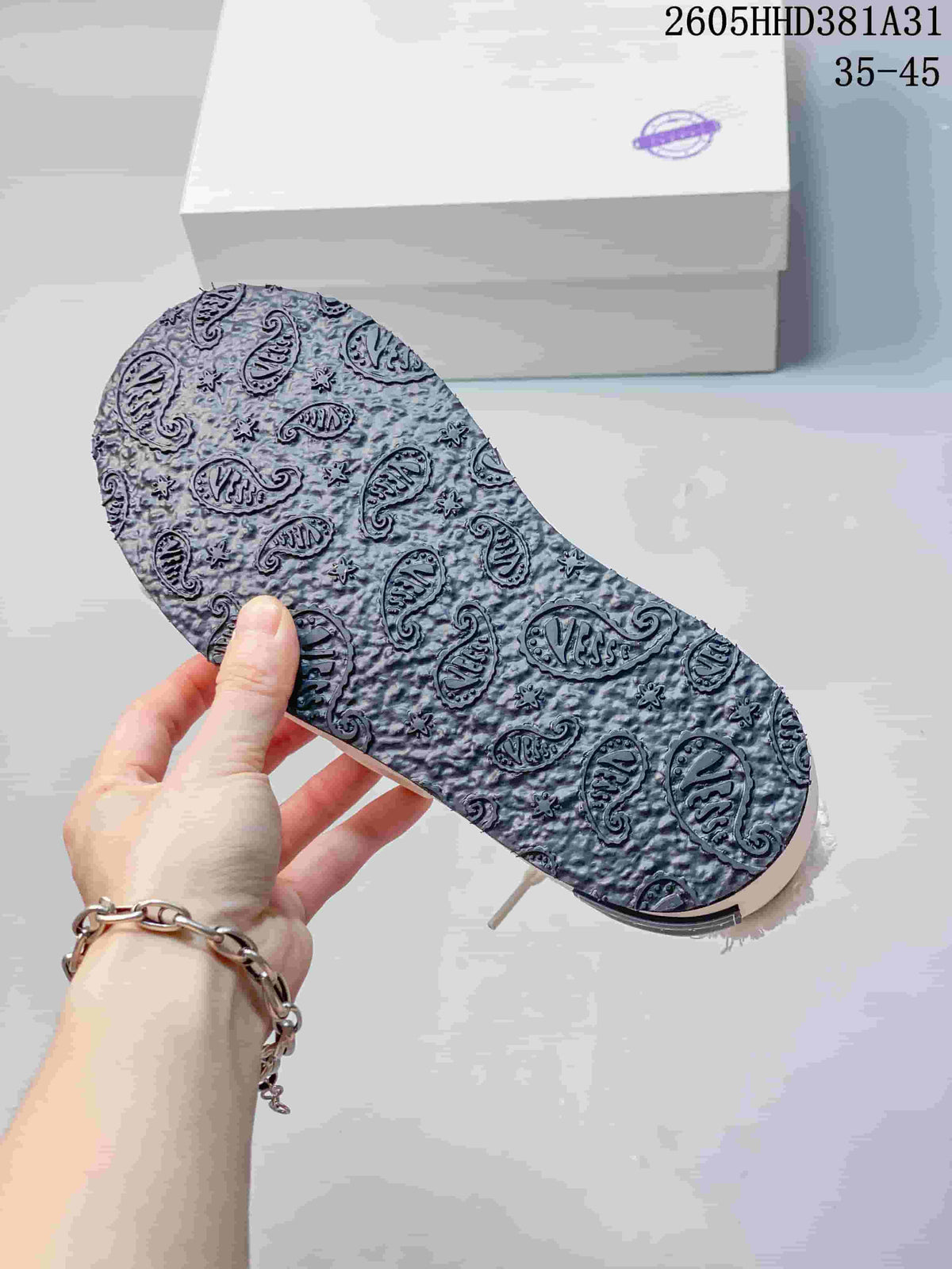Close-up of the patterned outsole on a white and gray xVESSEL G.O.P. Low sneaker