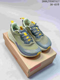 Pair of Altra Experience Wild 2 running shoes in green, blue, and yellow, shown from above.
