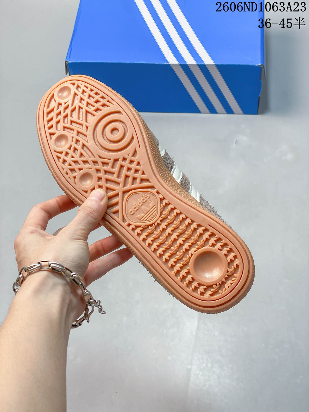 Gum-colored outsole with patterned tread on a taupe sneaker.