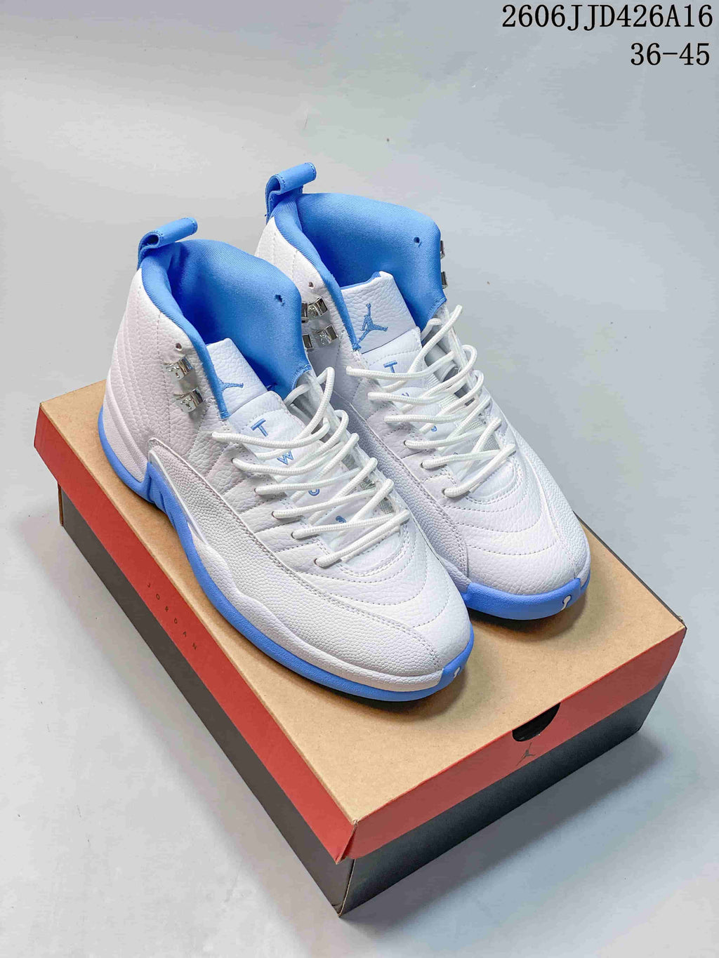 Pair of white and blue Jordan Air Jordan 12 high-top sneakers on a shoebox