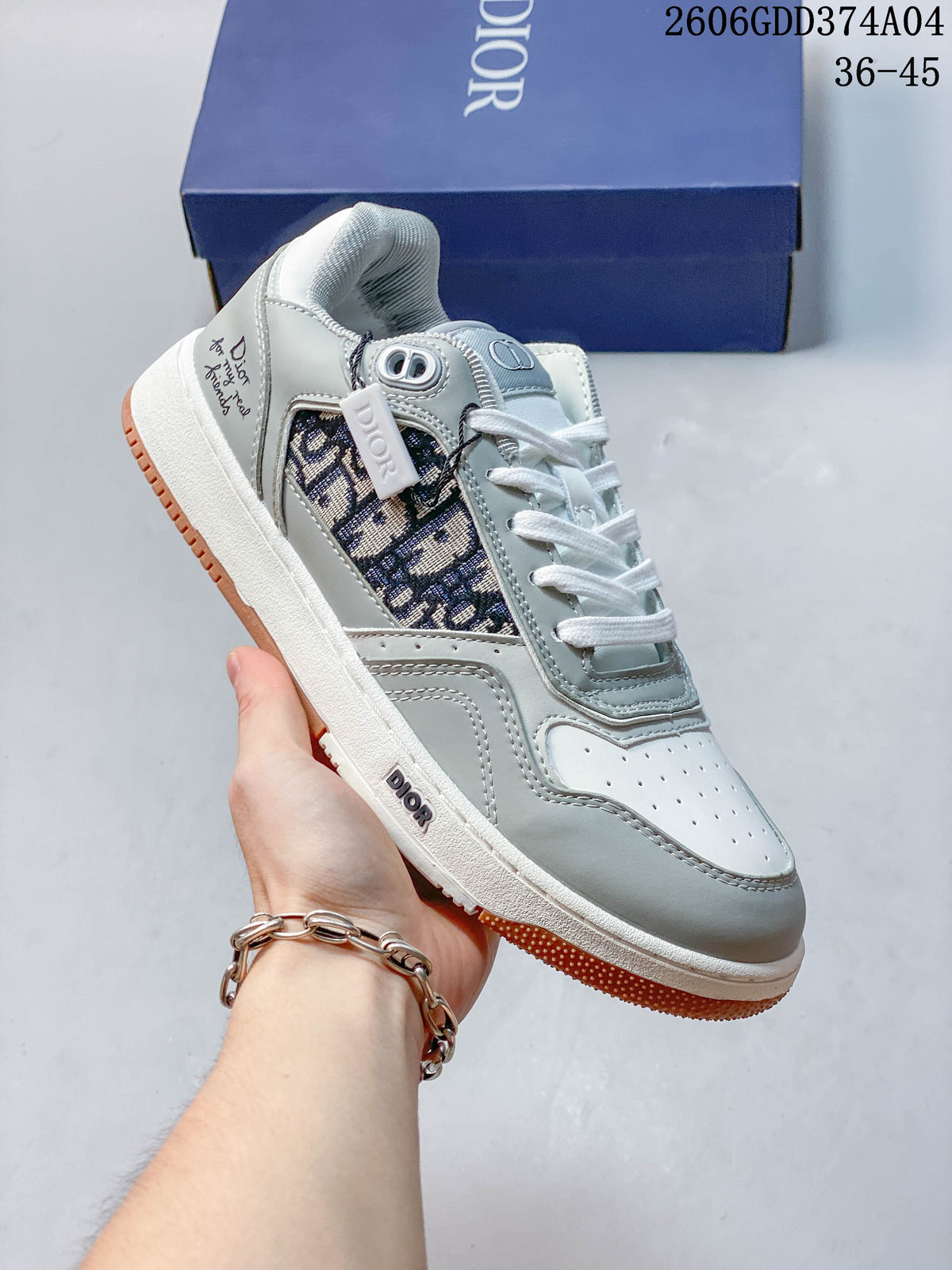 White and gray lace-up sneaker with a dark patterned side insert and gum-colored outsole accents.