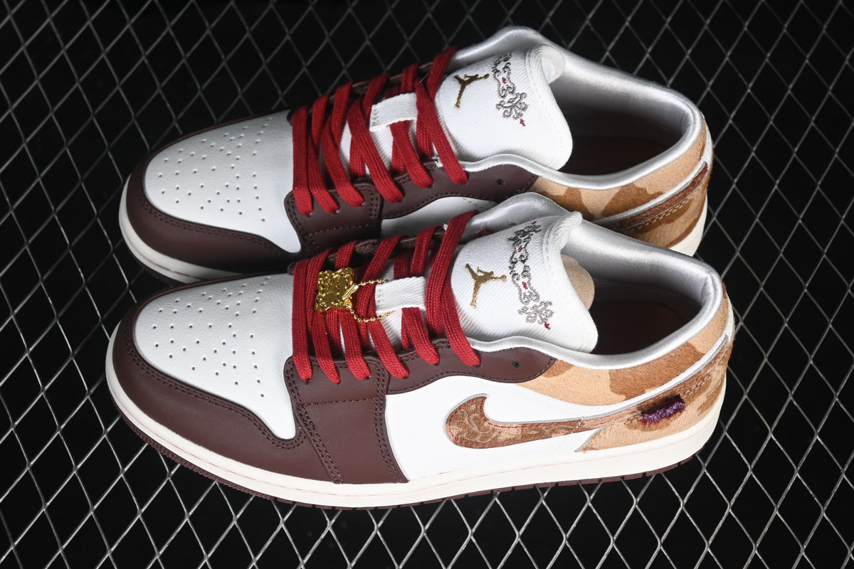 Pair of Air Jordan 1 Low sneakers with white, brown, tan, and red details