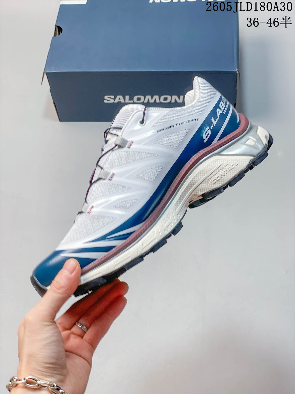 Side view of the white and blue Salomon XT-6 shoe
