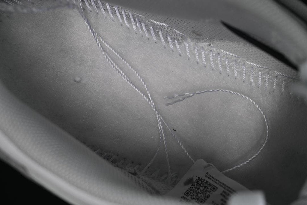 Close-up inside the sneaker showing interior stitching and a tag