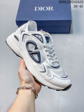 White low-top mesh sneaker with dark blue side details, held in front of a branded box.