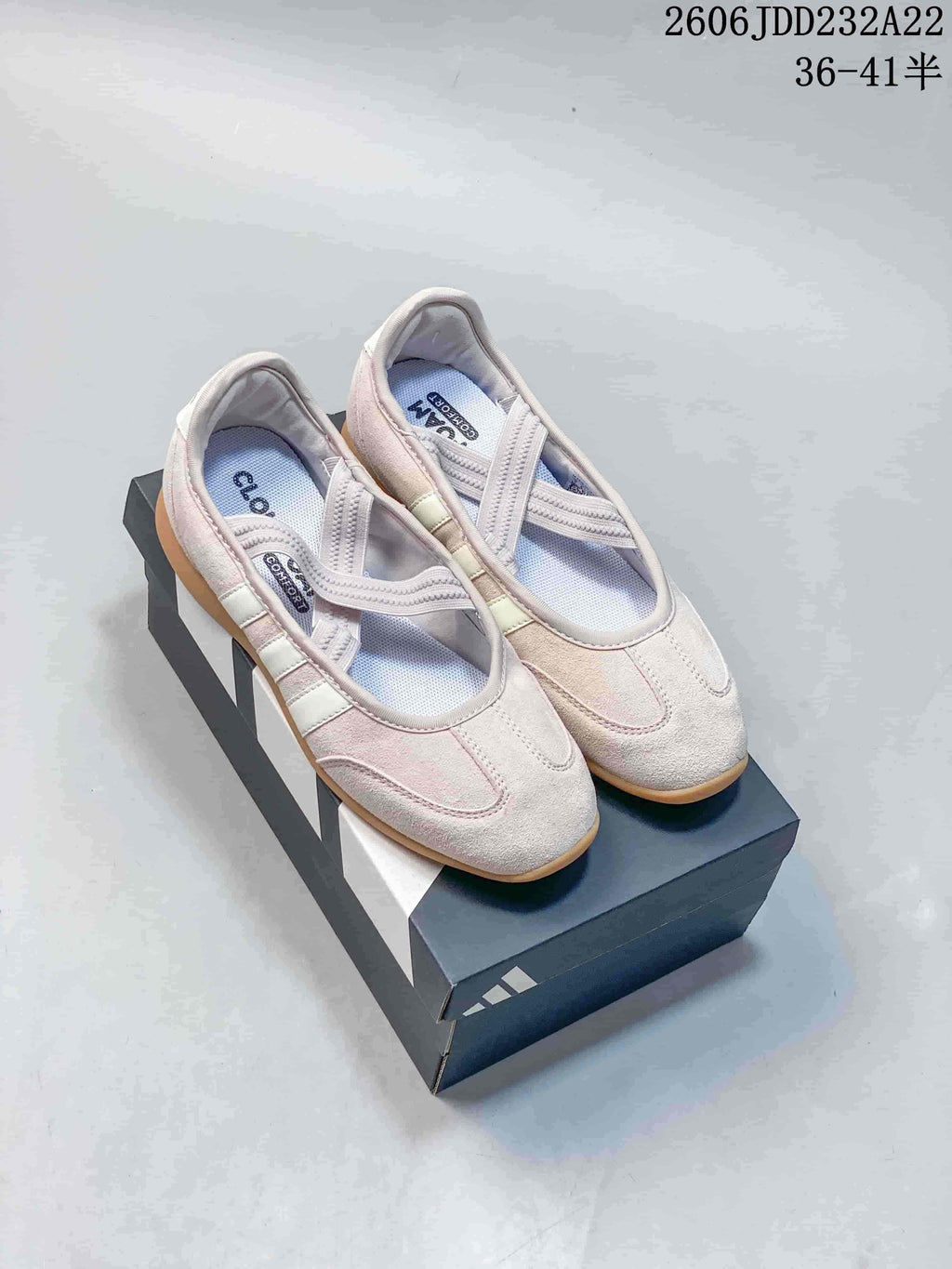Pair of light pink Adidas Barreda Mary Jane shoes with crossed straps and gum-colored soles