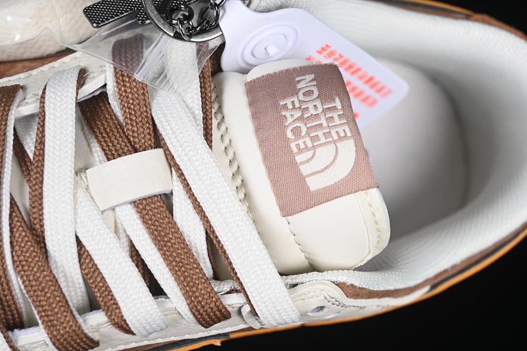 Close-up of tongue branding and alternating brown and off-white laces