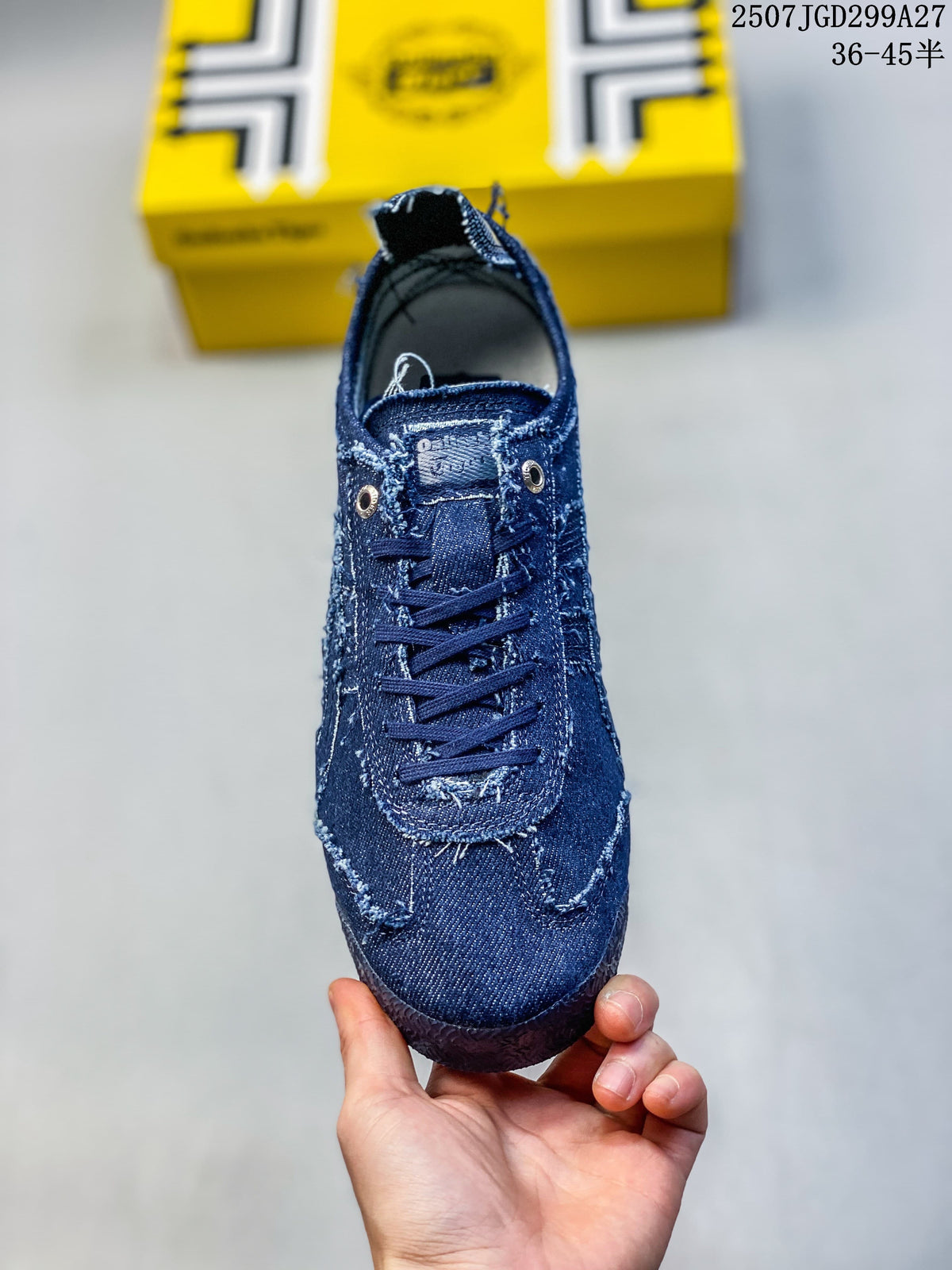 Front view of the dark blue sneaker with lace-up closure and metal eyelets