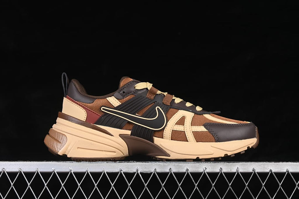 Side view of brown and beige Nike V2K Run sneakers with dark brown accents