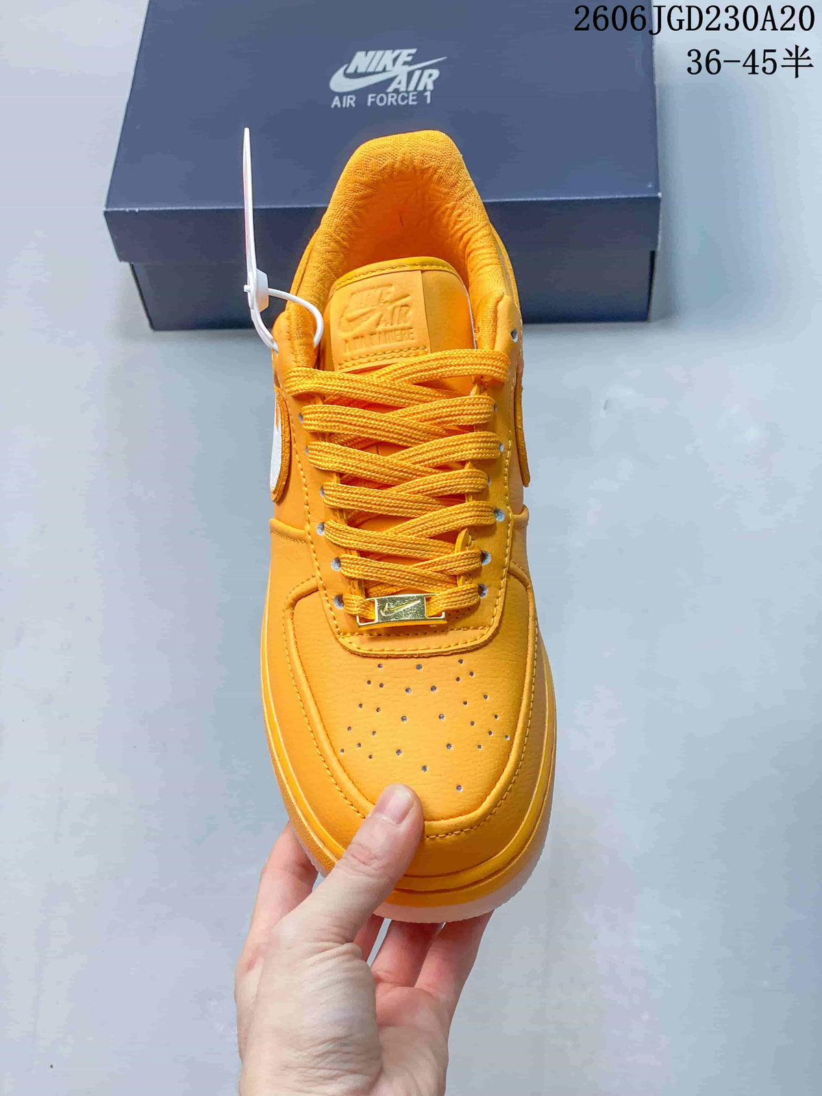 Top view of a yellow Nike Air Force 1 sneaker with matching laces and a perforated toe
