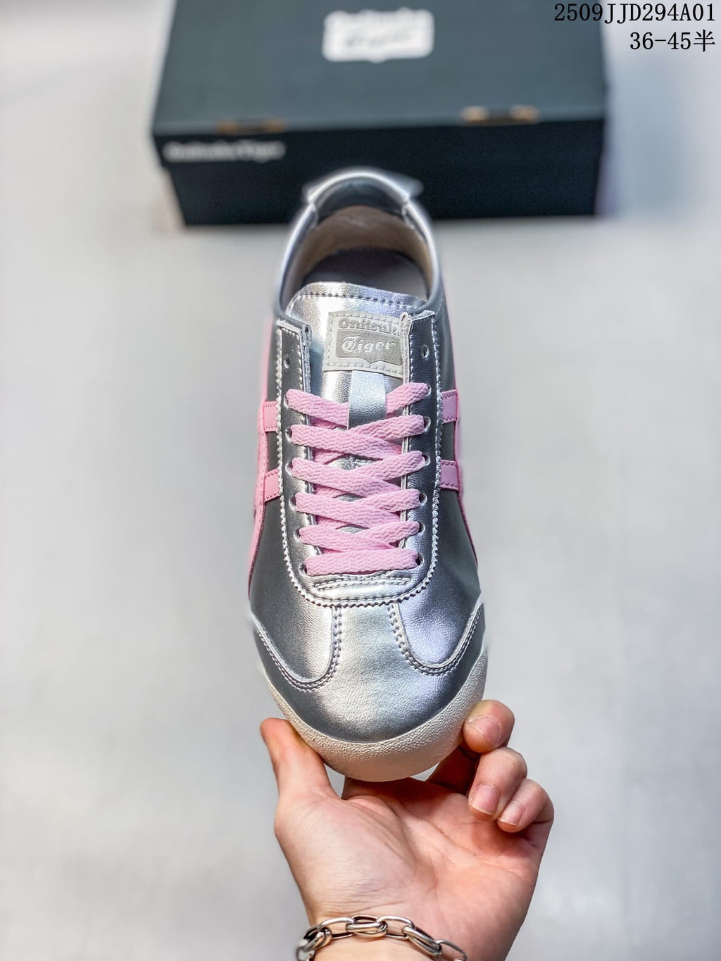 Front view of a silver sneaker with pink laces