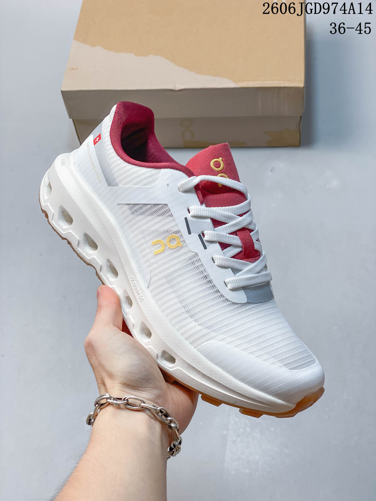 Angled side view of a white On Cloudvista 2 shoe with pink accents and a gum-colored outsole.