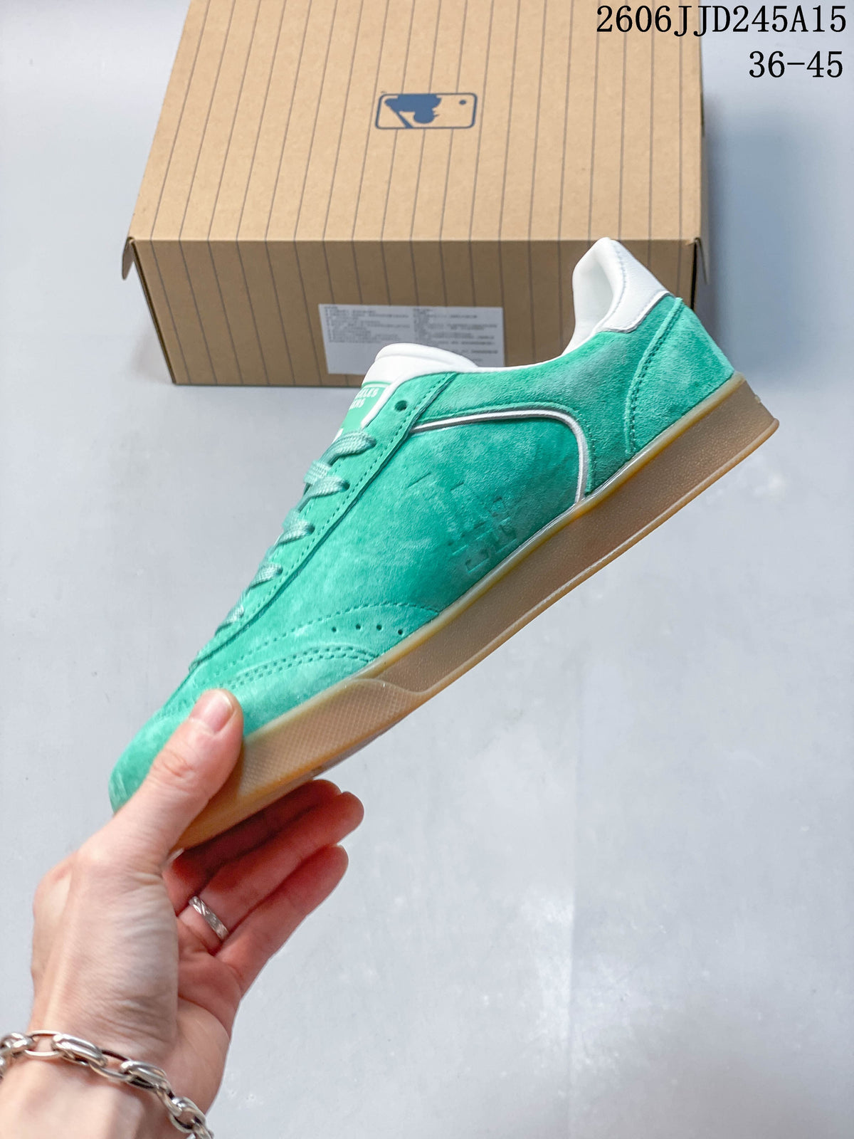 Side view of the teal Dodgers sneaker with white trim and a gum-colored sole.