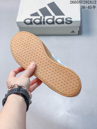 View of the textured gum-colored outsole beside an Adidas shoebox; the image shows the printed range 36–45.