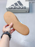 View of the textured gum-colored outsole beside an Adidas shoebox; the image shows the printed range 36–45.