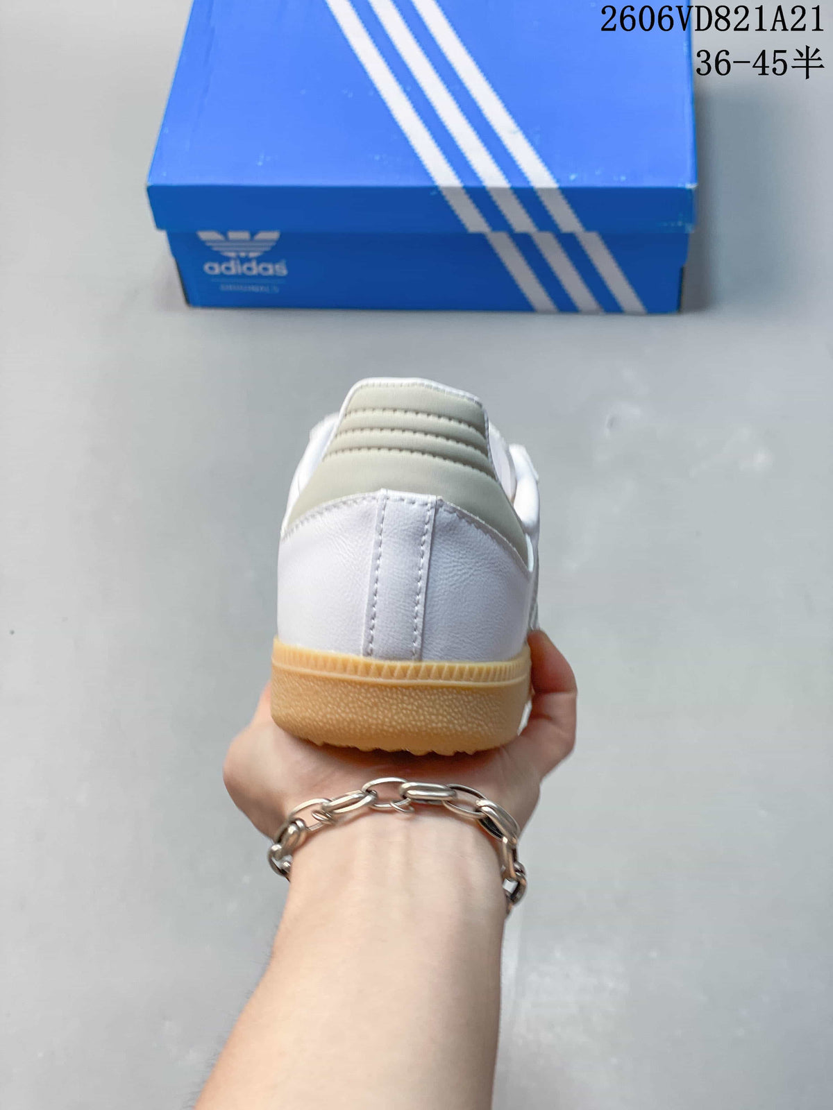 Rear view of a white sneaker with a gum-colored sole.