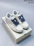 Pair of off-white low-top sneakers with navy patterned laces and graphic side panels