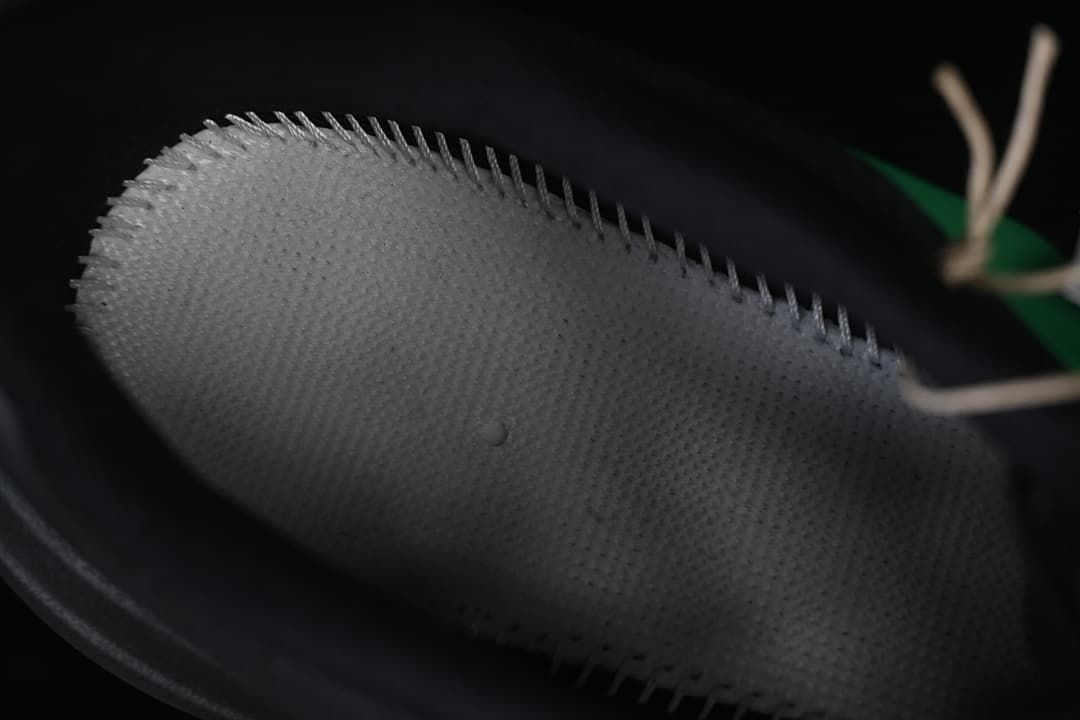 Close-up of the shoe's inner heel collar and stitching.