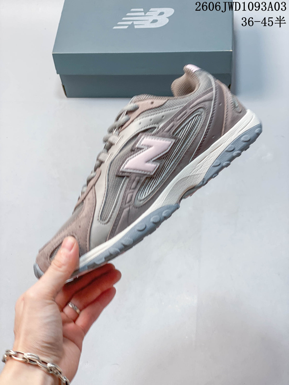 Side profile showing layered panels, mesh sections, and pale pink logo accents