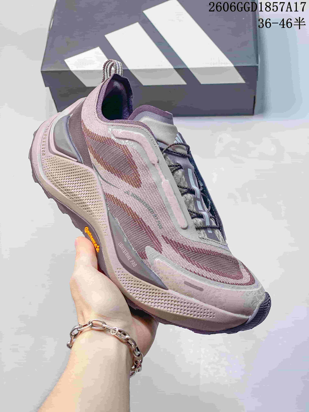 Side view of a muted pink adidas HOLO PEAK trail shoe.