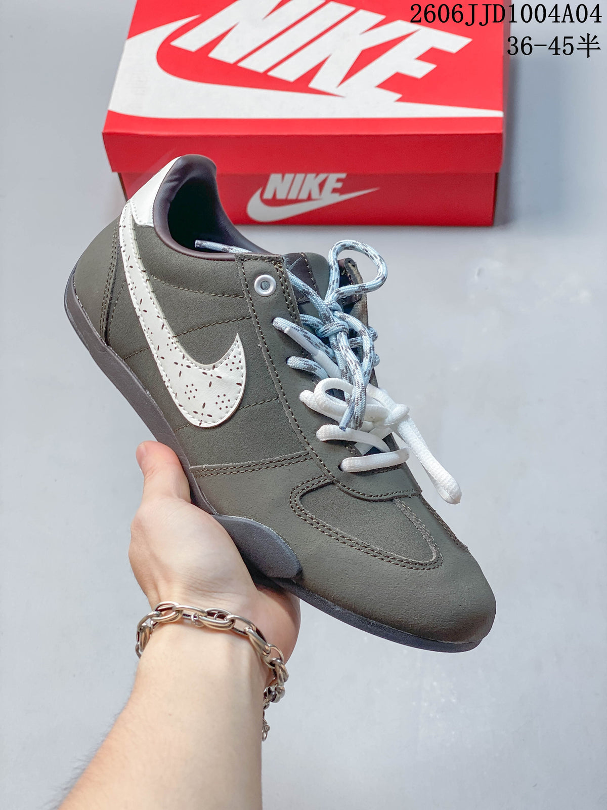Angled side view of a gray Nike Sprint Sister sneaker with a light-colored Swoosh