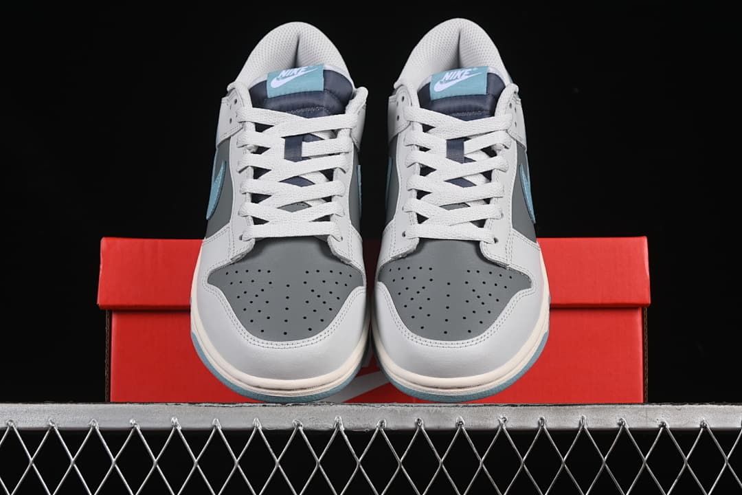 Front view of both sneakers resting on the shoe box