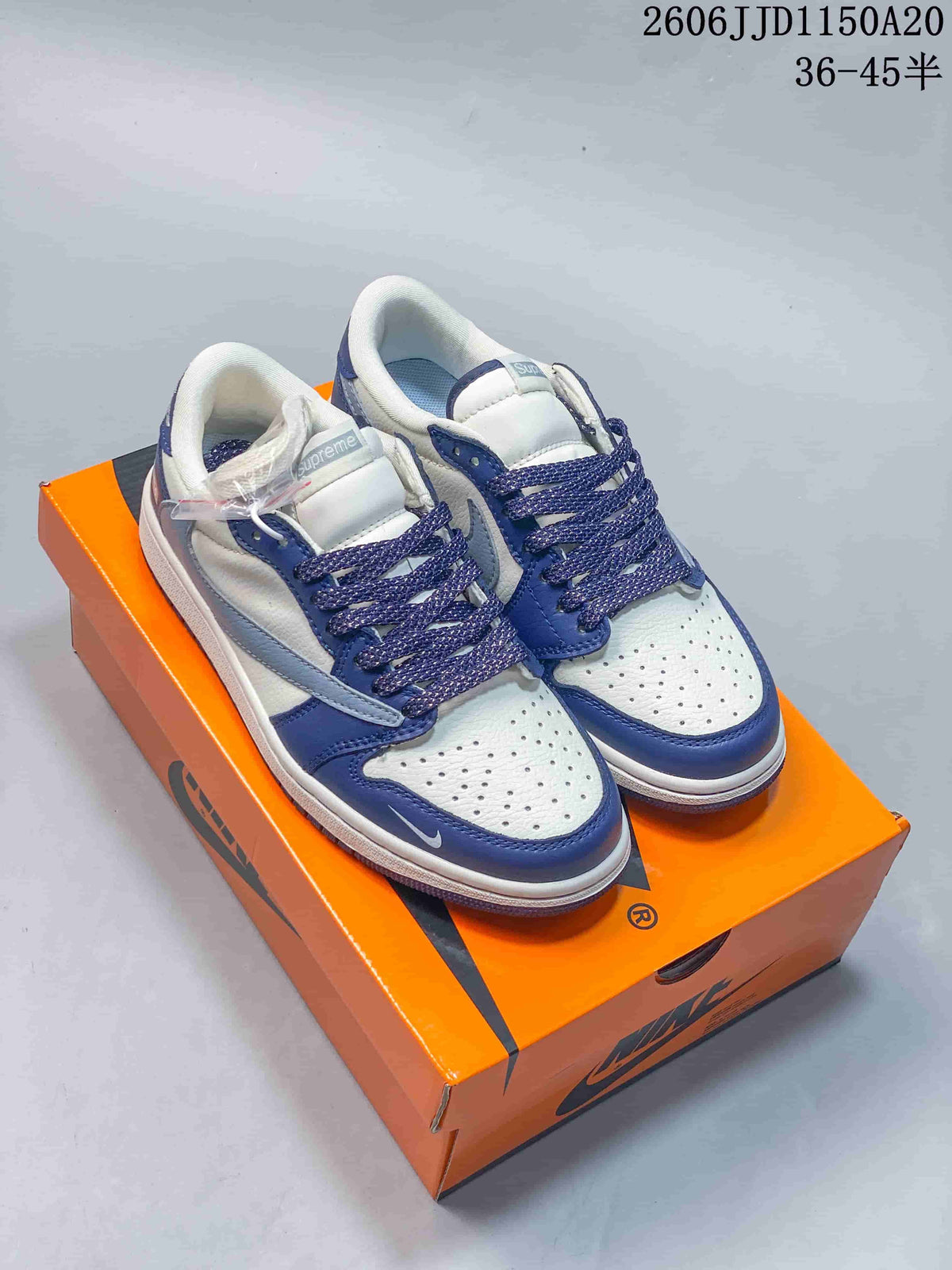 Blue and white low-top sneakers with perforated toe panels and dark blue laces.