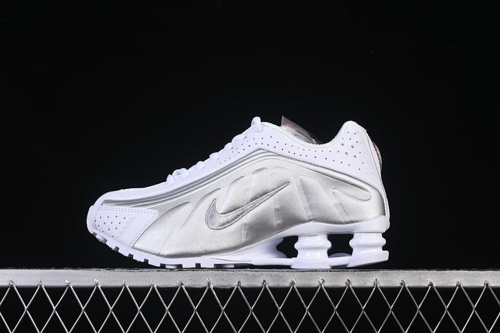 Side profile of a white and metallic silver sneaker