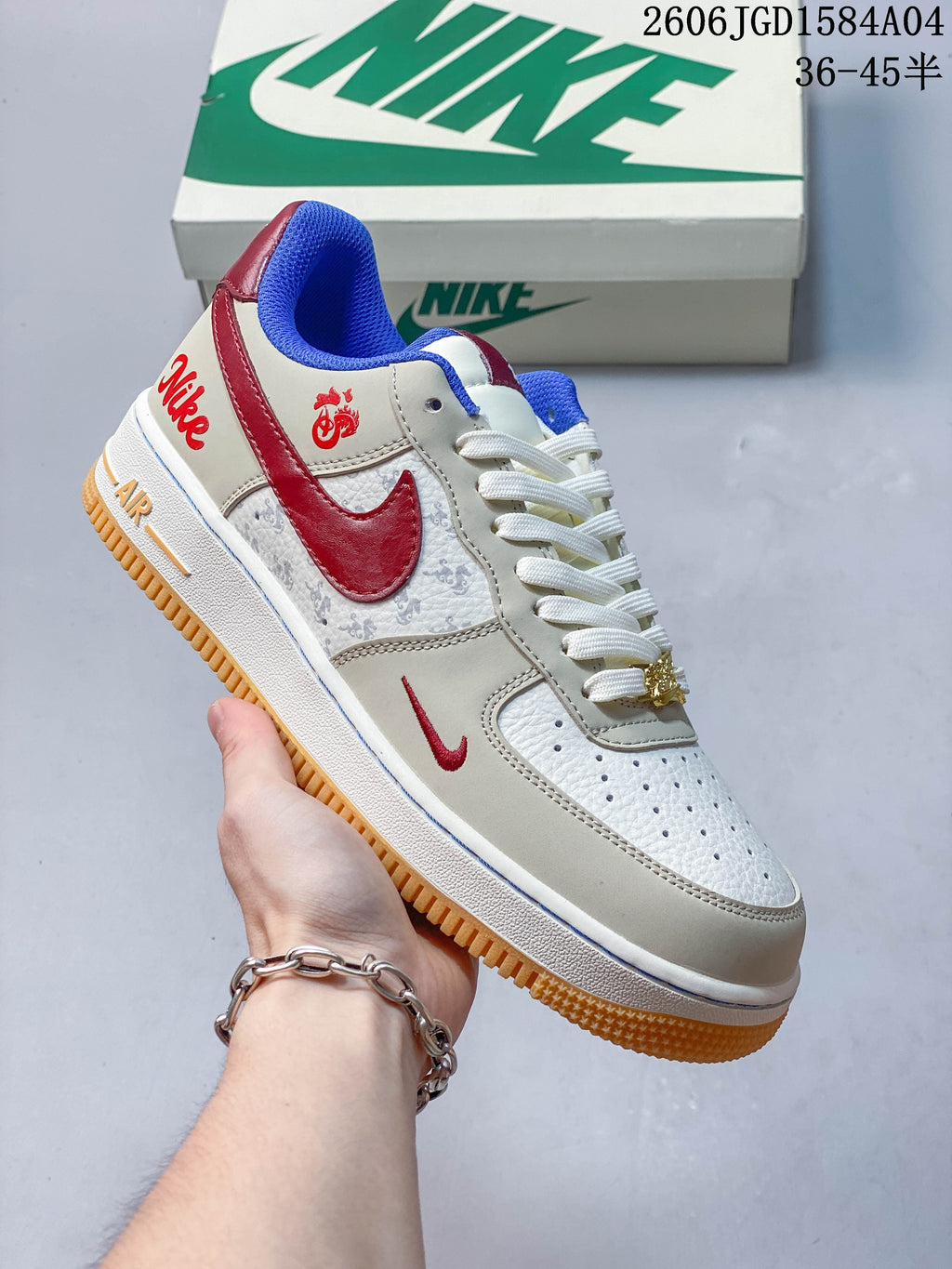 Angled side view of the sneaker with red accents and decorative panels
