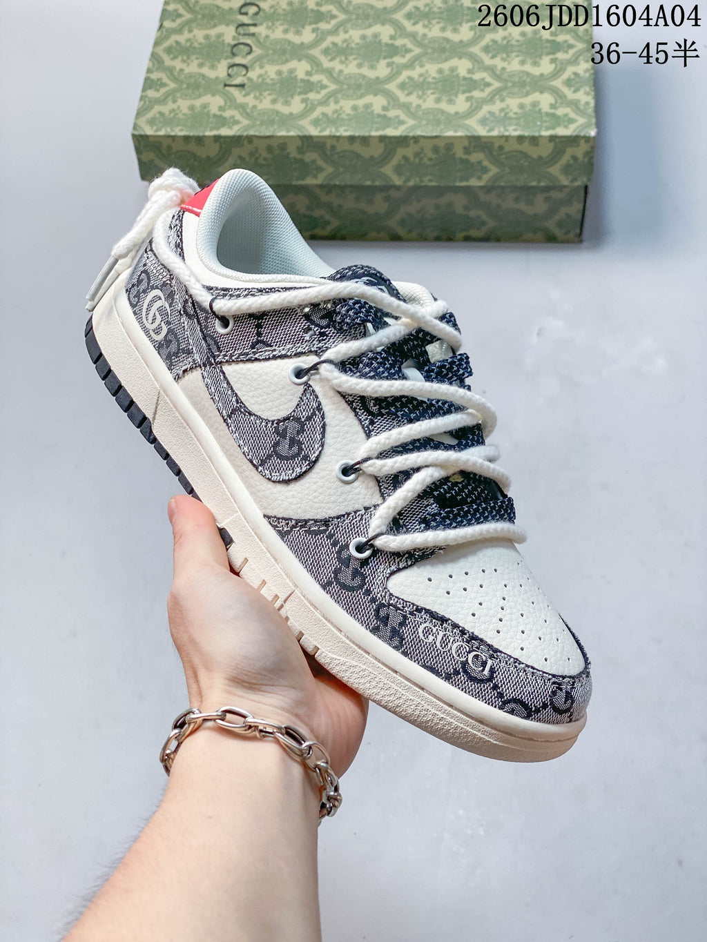 Gray patterned and cream low-top sneaker with thick white laces, shown beside a patterned box.