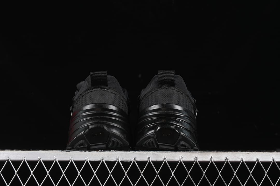 Rear view of both sneakers showing heel loops and outsole shape.