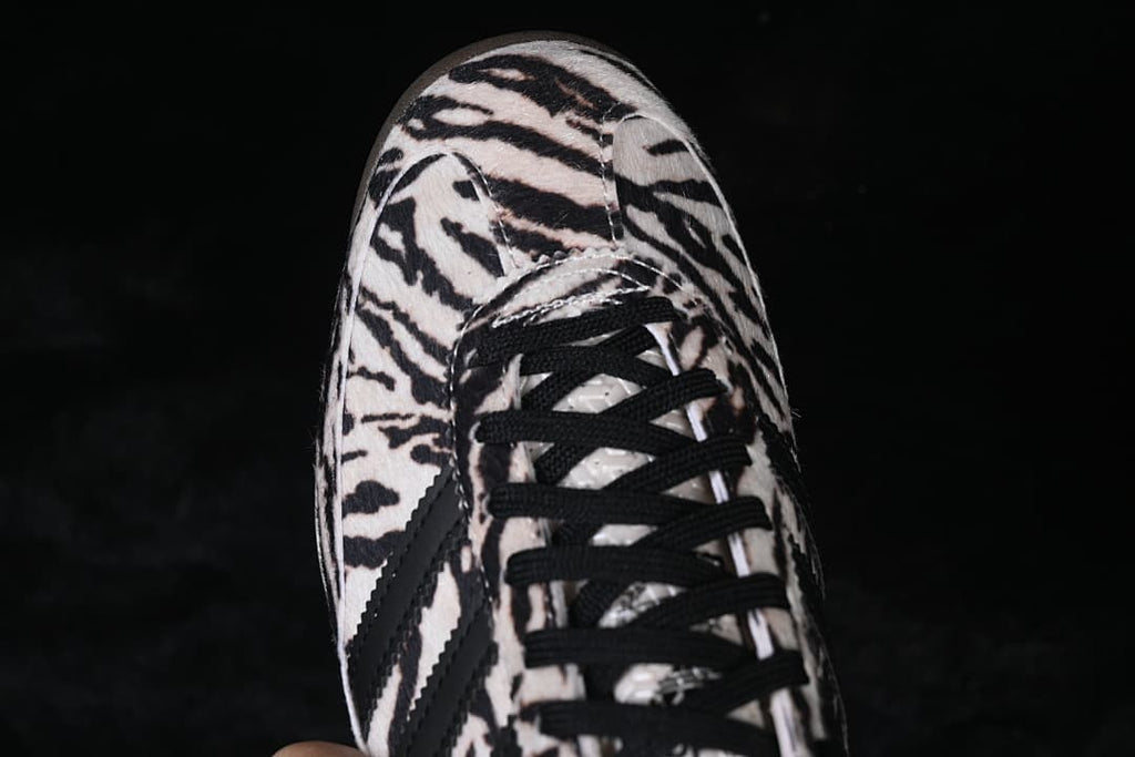 Top view of the sneaker showing its animal-print toe and black laces.