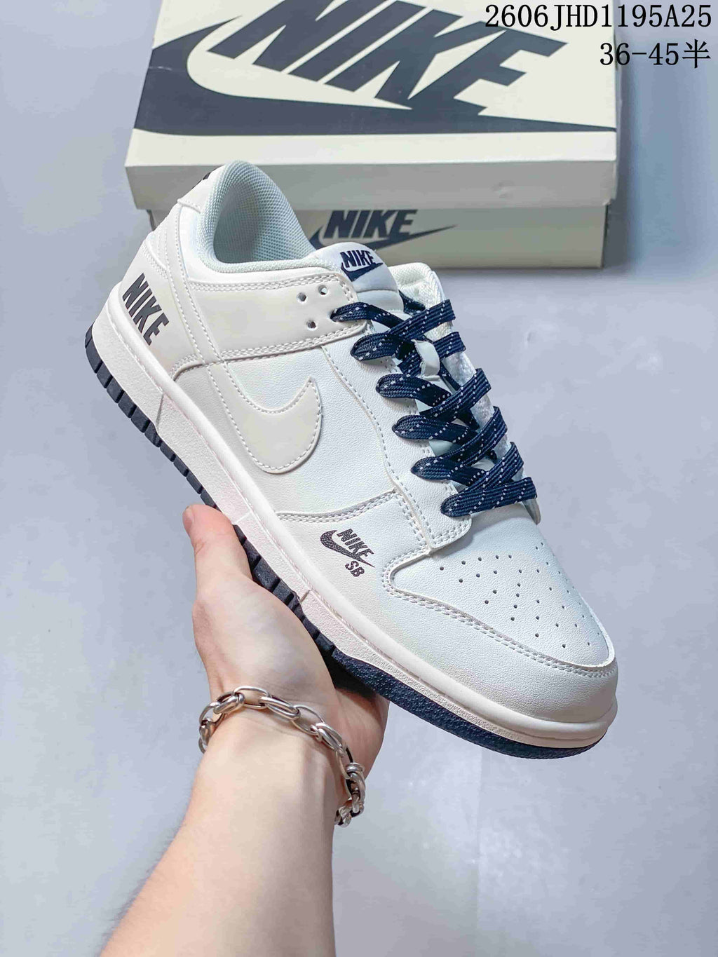 Close-up of a white low-top sneaker with navy laces and dark outsole accents