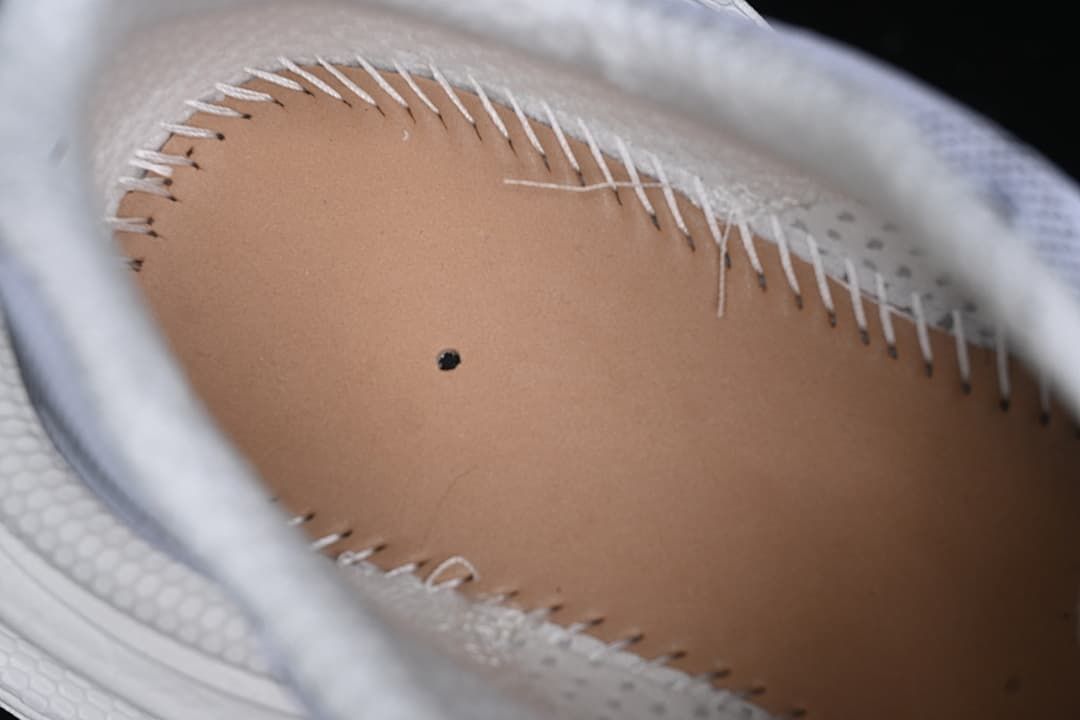 Close-up of the sneaker interior and stitched insole edge.