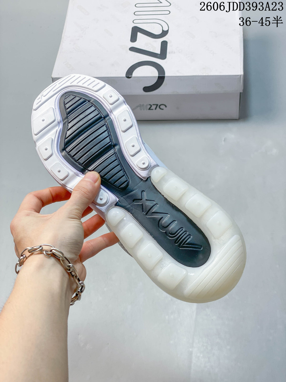 Underside of a white Nike Air Max 270 sneaker showing the outsole and heel unit