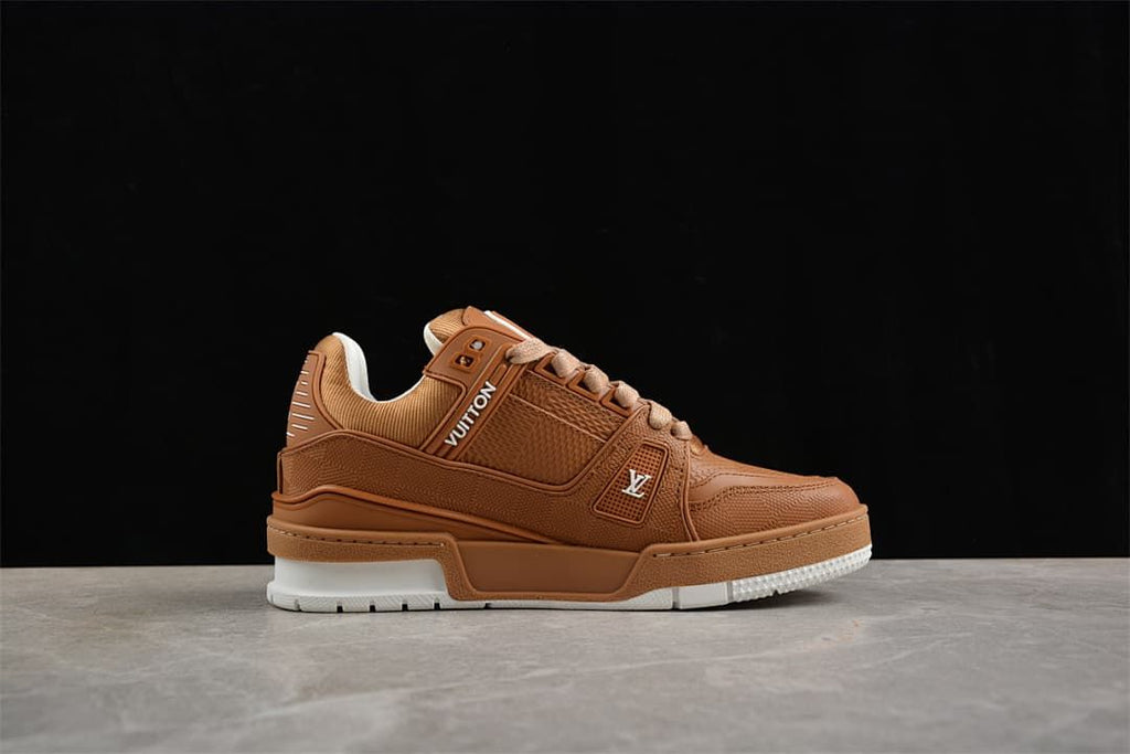Side profile of the brown low-top sneaker with tan laces and white outsole.