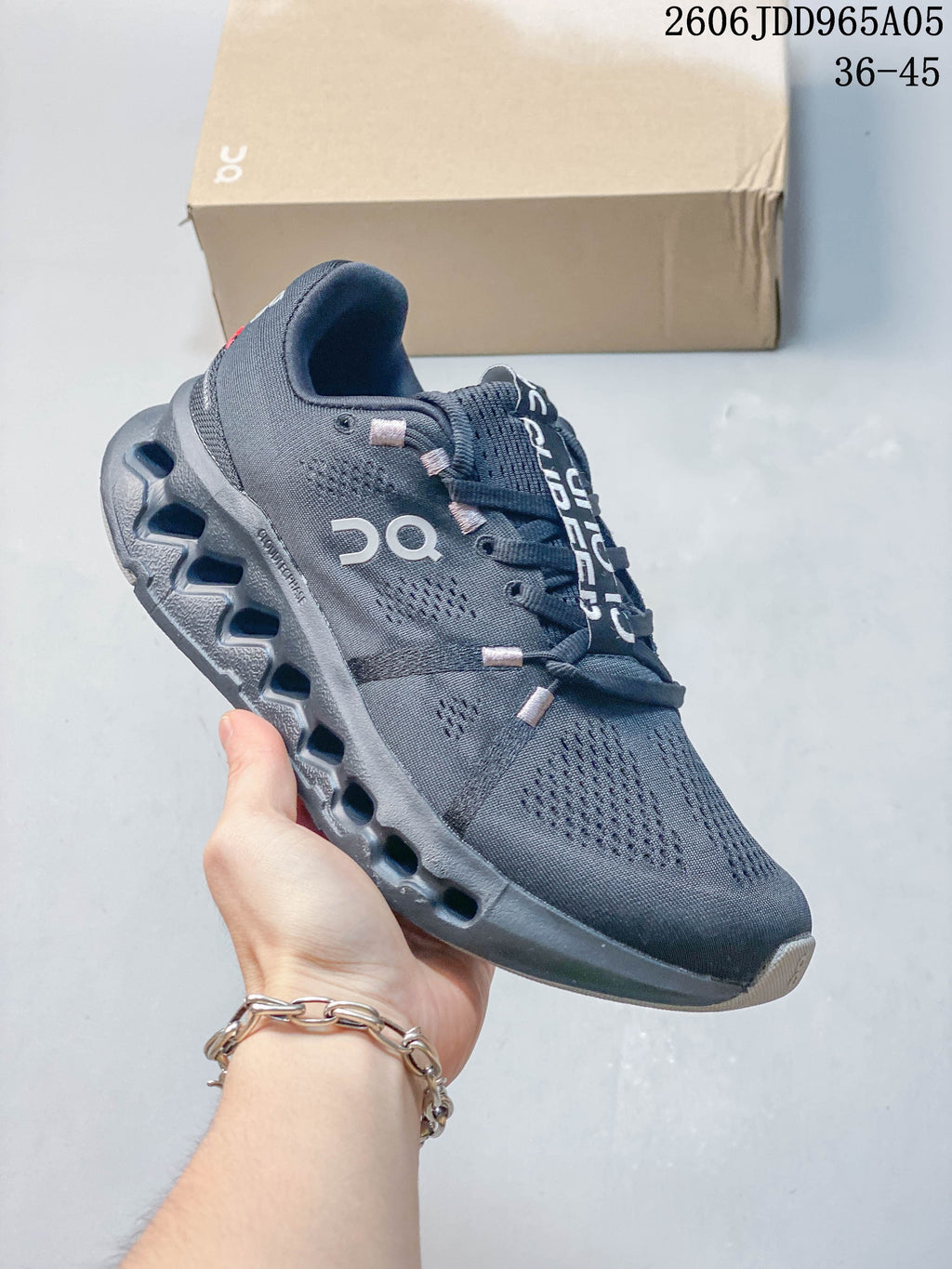Charcoal On Cloudsurfer Trail shoe with a dark sculpted sole